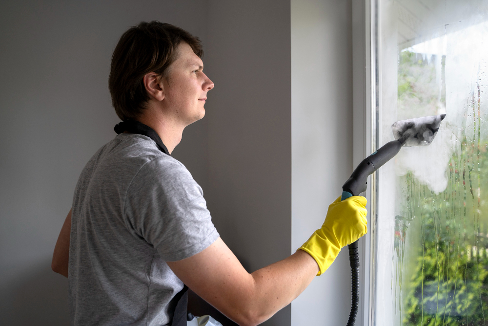 worker cleaning a window